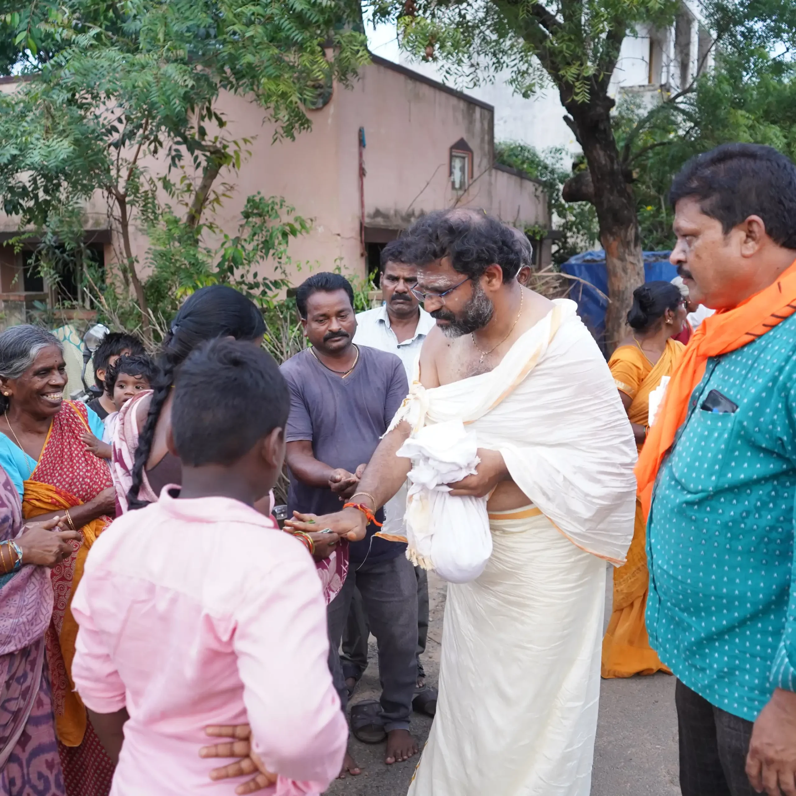 Receive the blessed prasadam as a token of divine grace